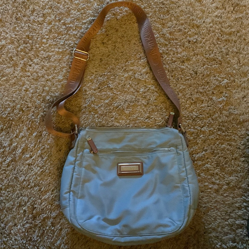 Woman’s light blue or teal crossbody calvin Klein bag